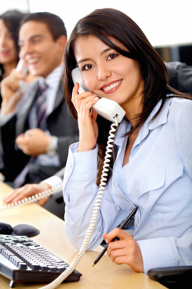 customer support team lead by a friendly girl smiling in an office